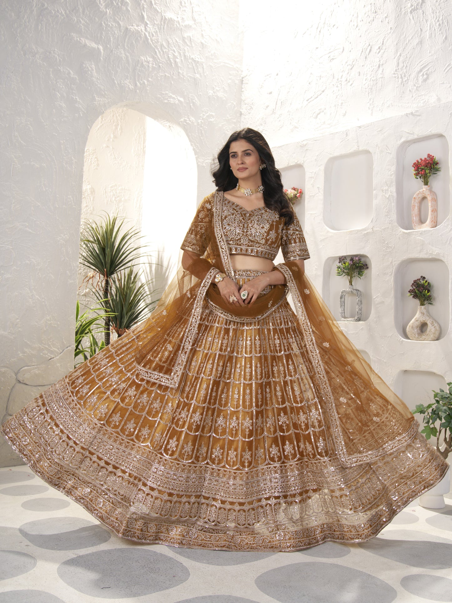 Precious Brown Heavy Embroidered Net Engagement Lehenga Choli
